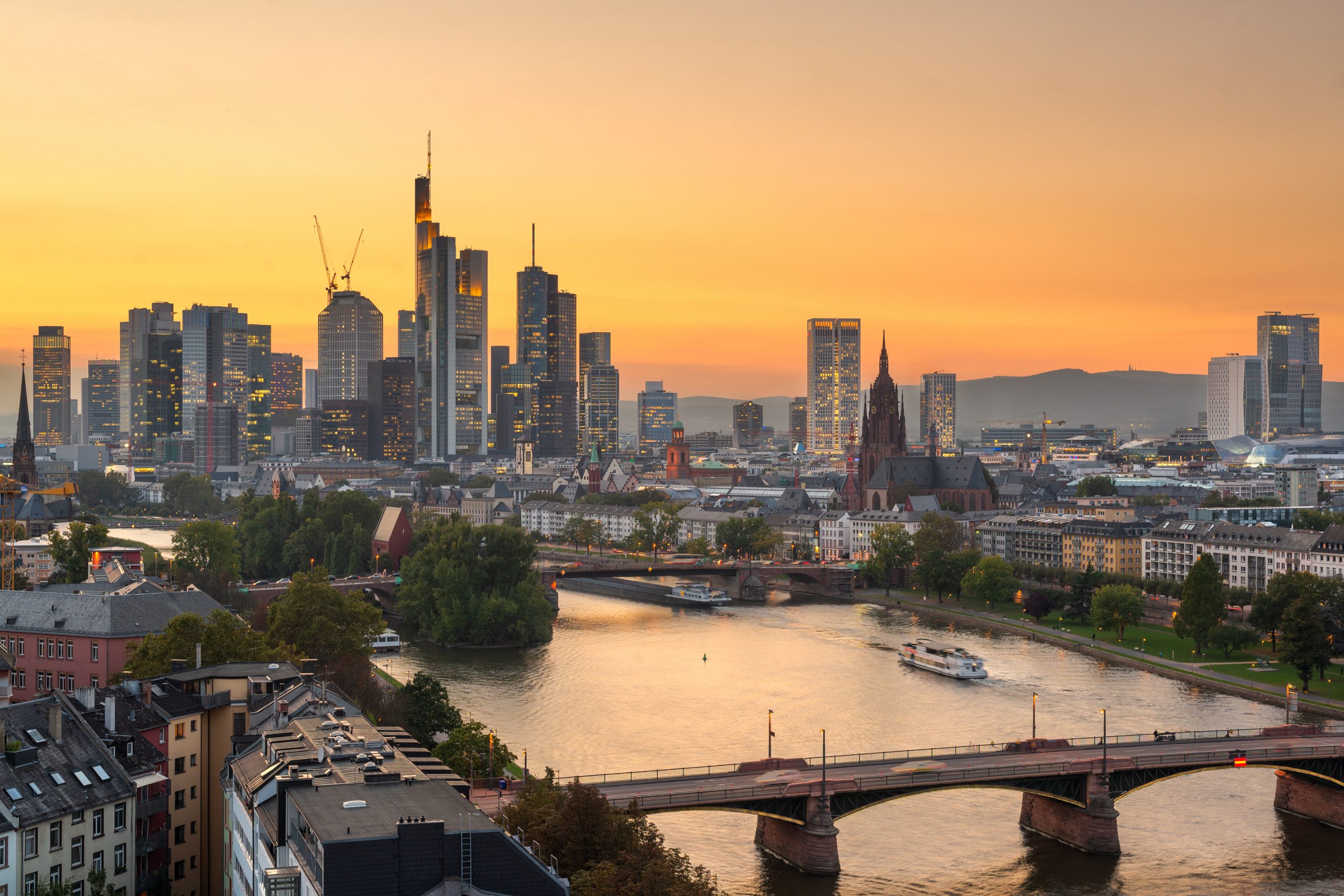 Frankfurt, Germany skyline over the Main River at dusk.